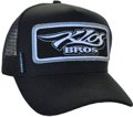 SNAPBACK TRUCKER HAT ACRYLIC FABRIC WITH BIG SEWN-ON PATCH ON FRONT CROWN AND WOVEN SIDE TAB